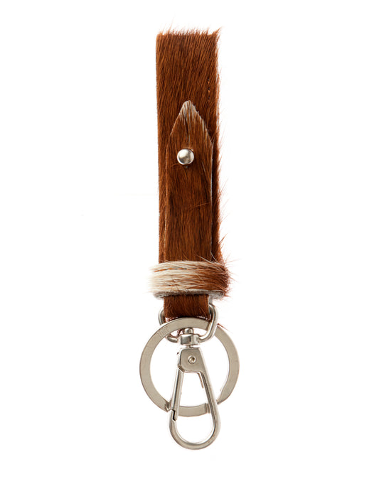 Keychain with brown hair extension and metal clasp on a white background