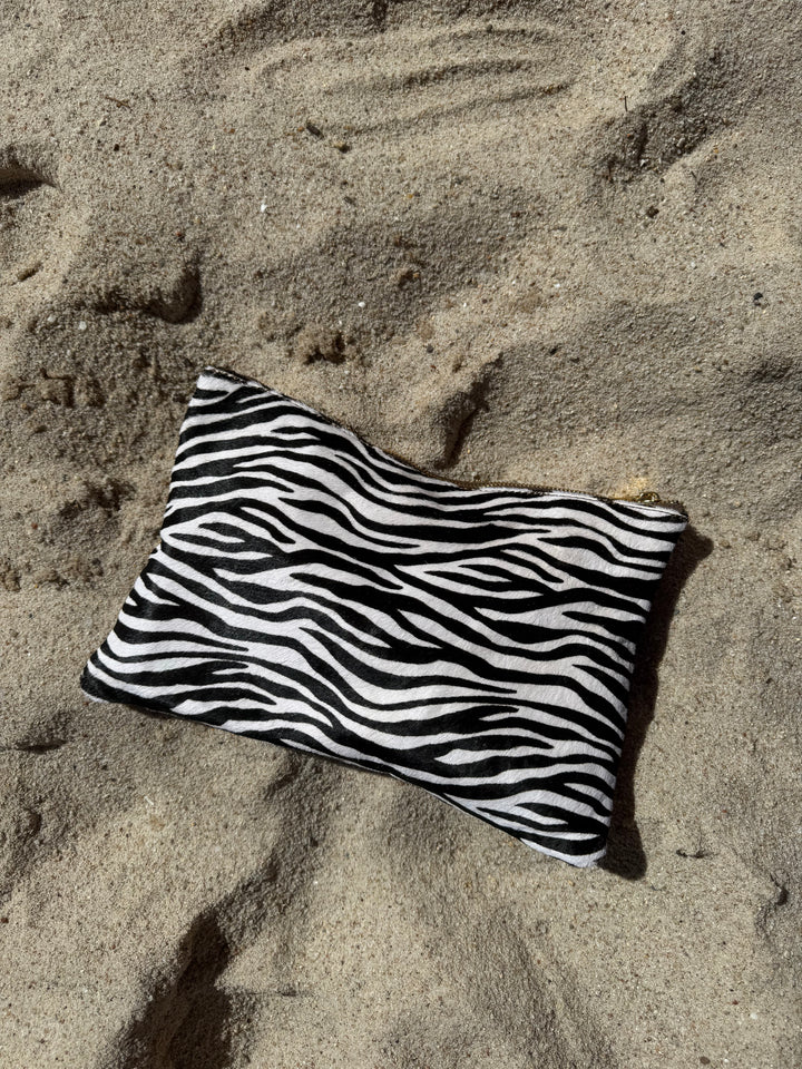 Zebra print pony hair and cowhide pouch, styled