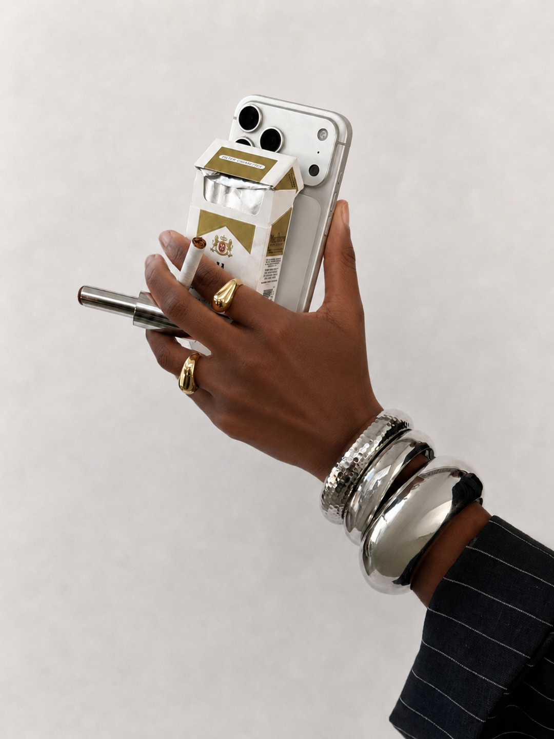 Hand holding a smartphone with a white background
